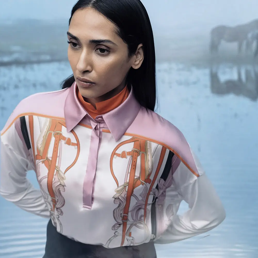 Bright orange turtleneck, silk blouse with bridle-inspired details