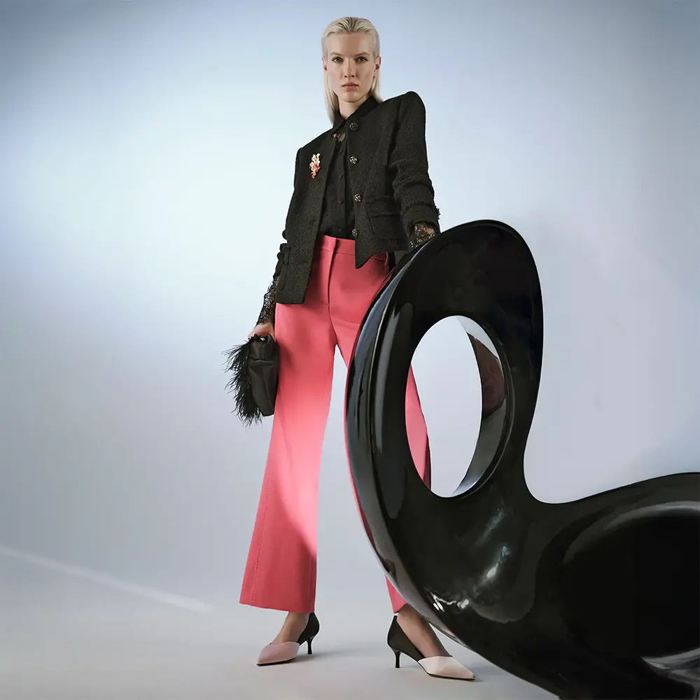 Black tweed jacket with lace blouse and pink pants