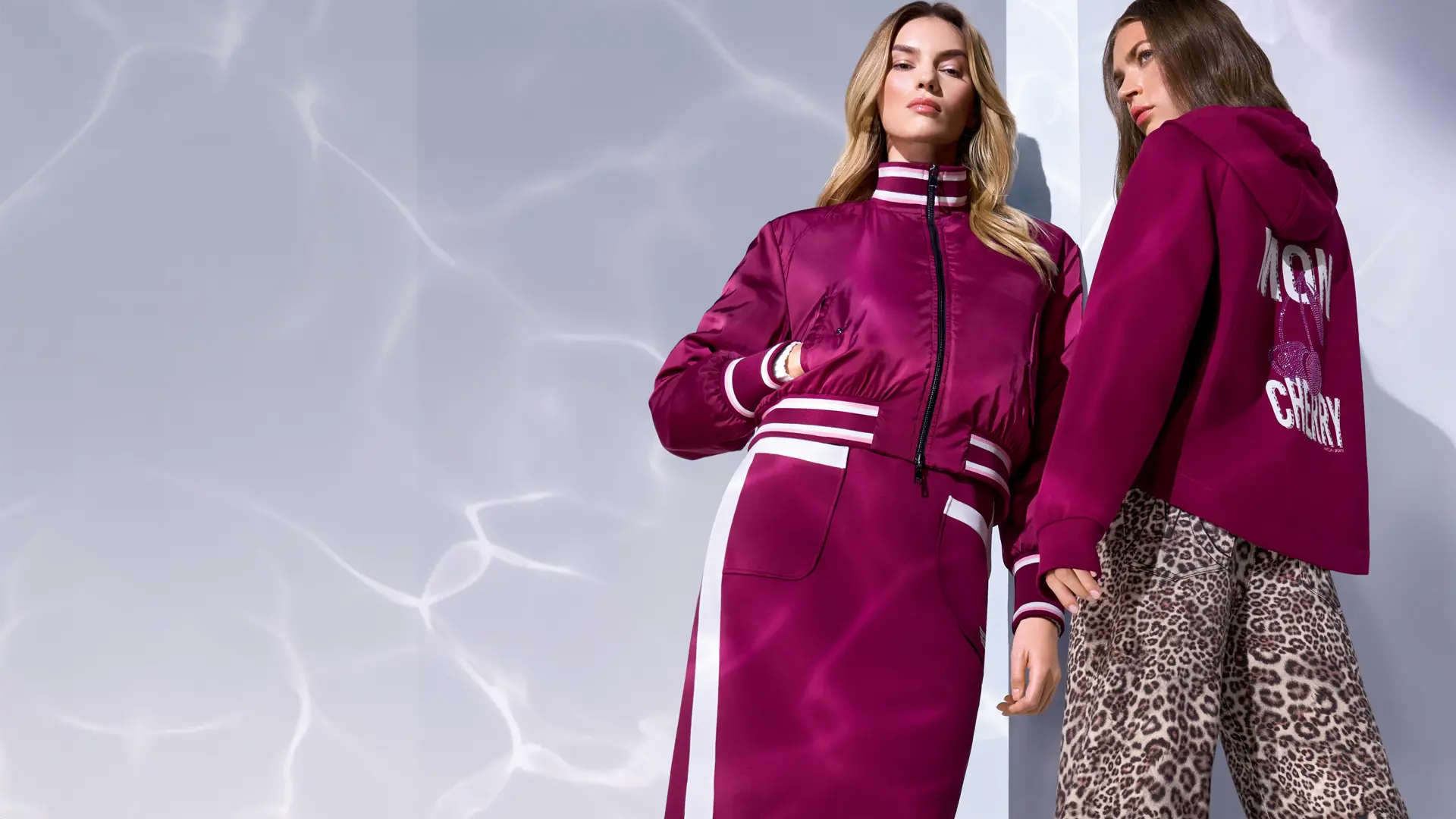 Mon Cherry wearing a reversible bomber jacket and sweatshirt with cherry print