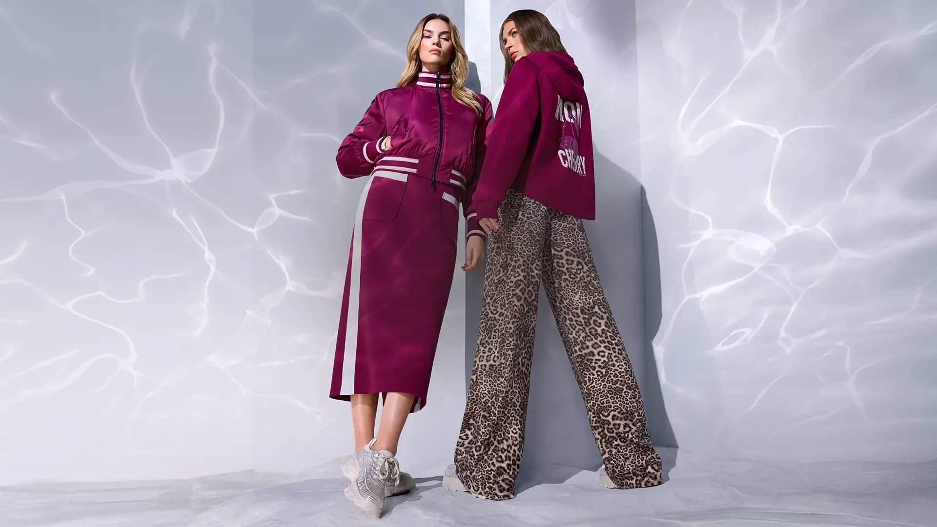 Mon Cherry wearing a reversible bomber jacket and sweatshirt with cherry print