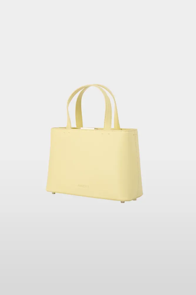 Handbag made from high-quality leather with two handles and a three-colour shoulder strap, butter yellow