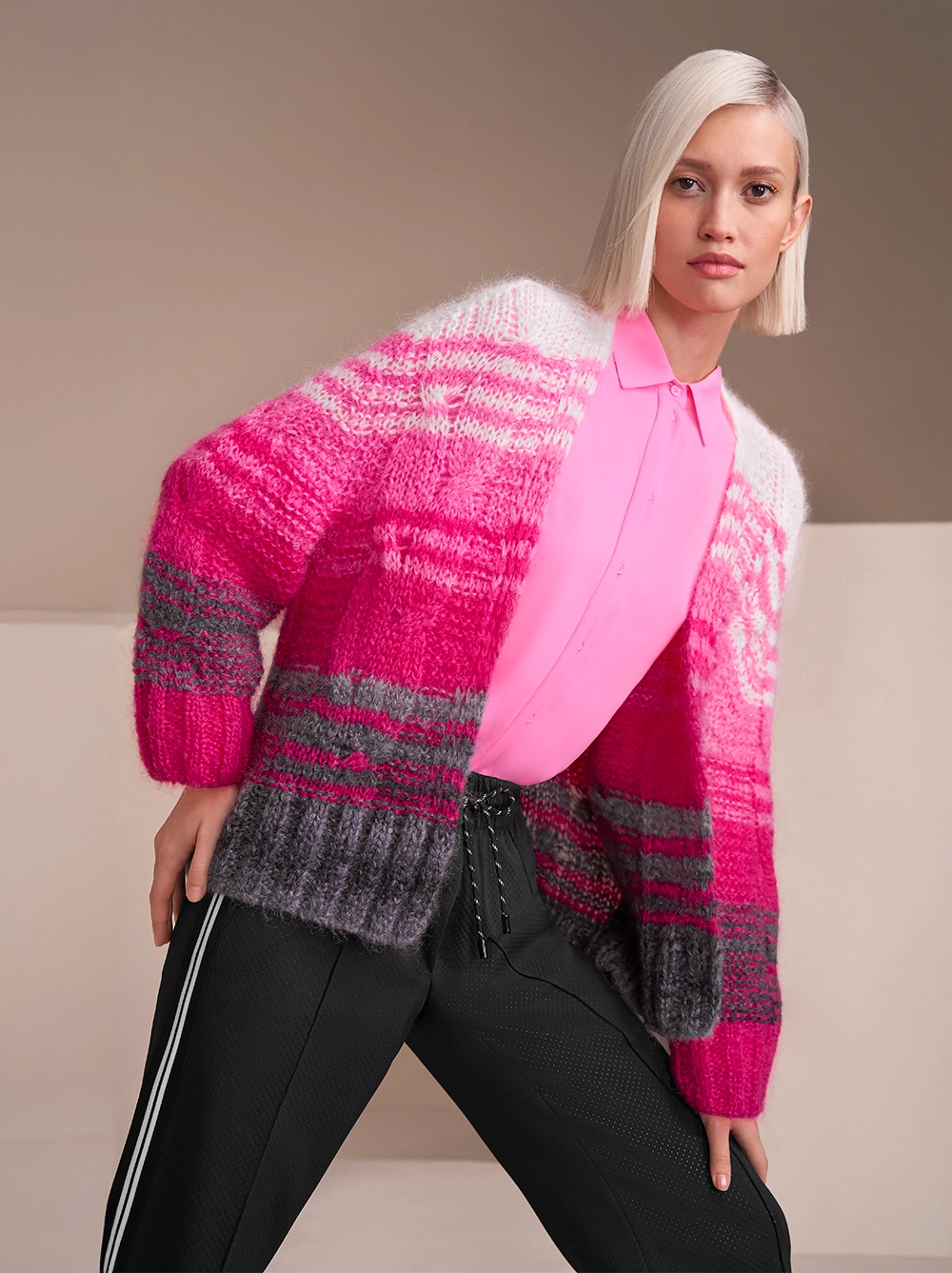 Pink-gestreifter Rethink Together Cardigan mit pinker Bluse und einer sportlichen, schwarzen Hose