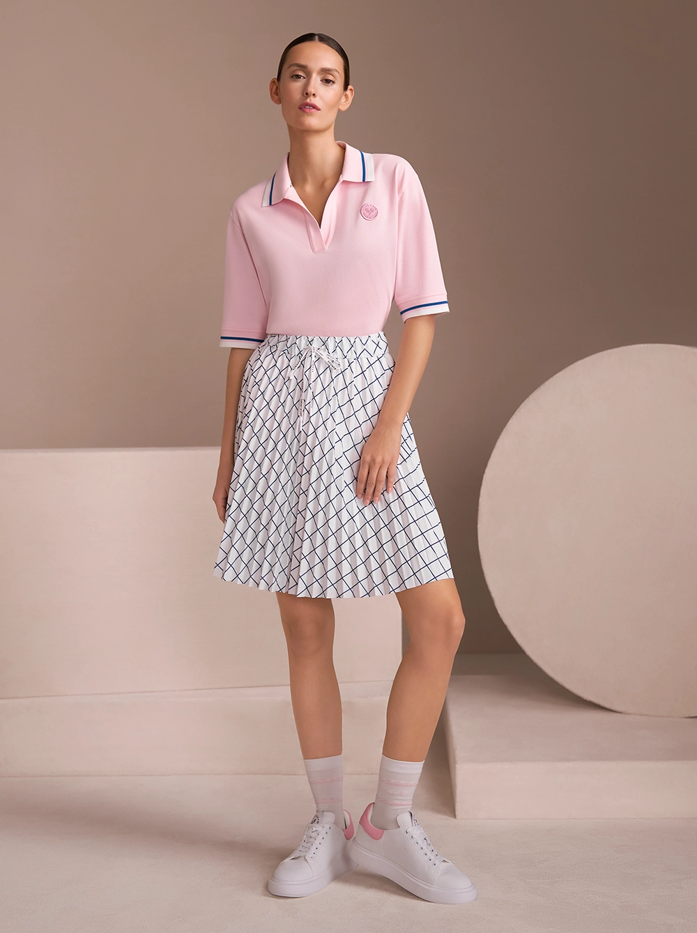 Rosafarbenes Poloshirt mit weiß/blau gestreiftem Tennisrock