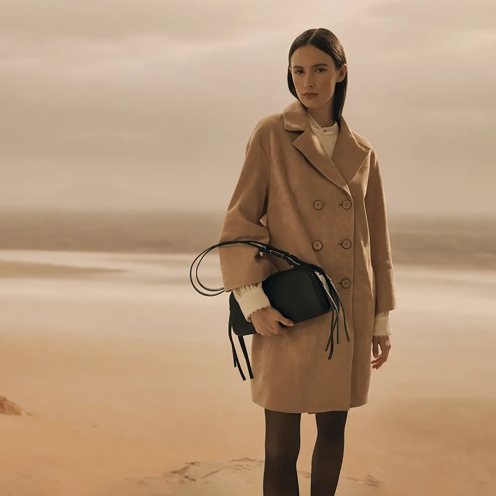 Brown leather coat with pocket and white blouse underneath