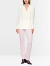 Flowing blouse with decorative button