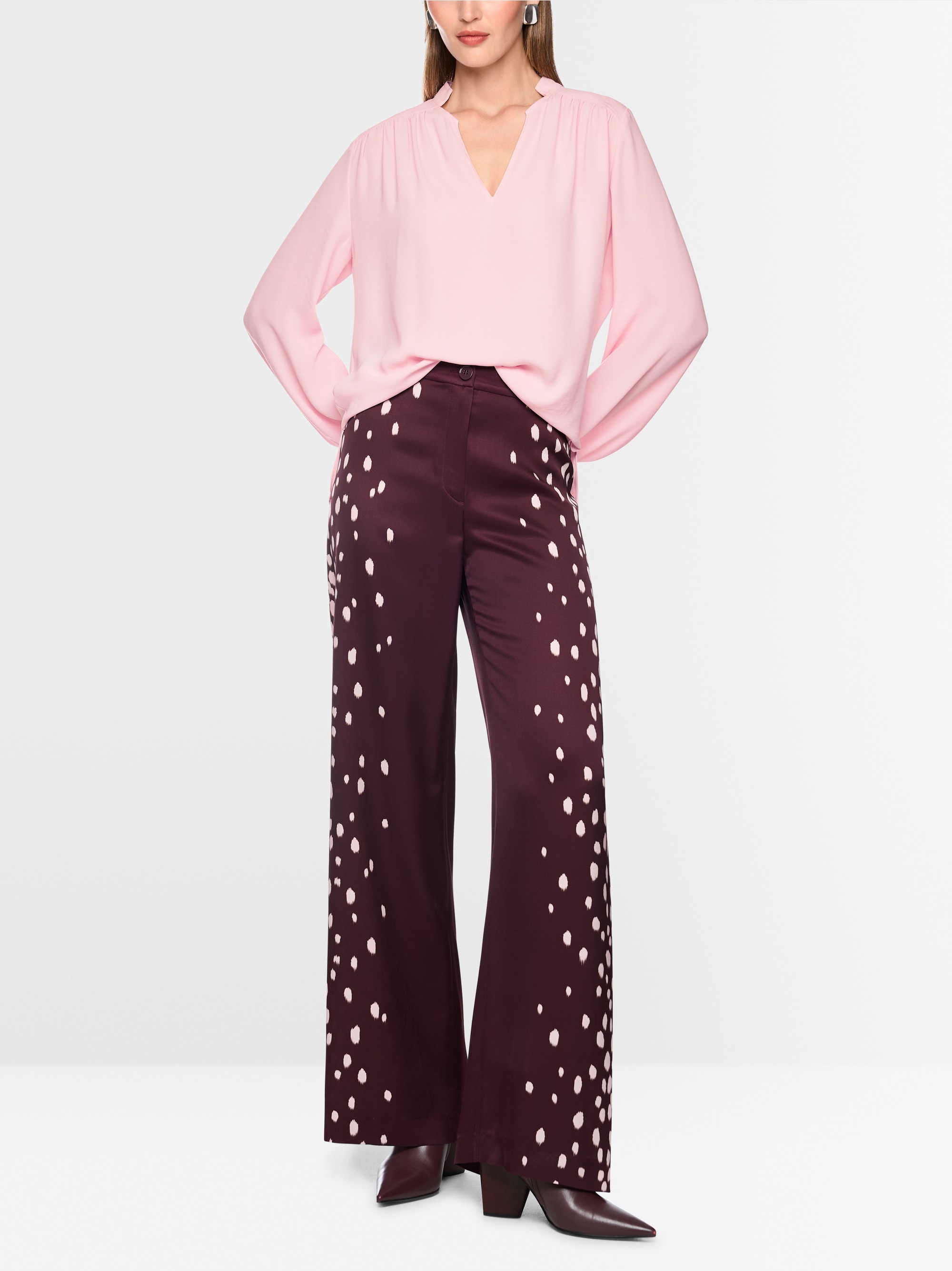 Flowing blouse with decorative button