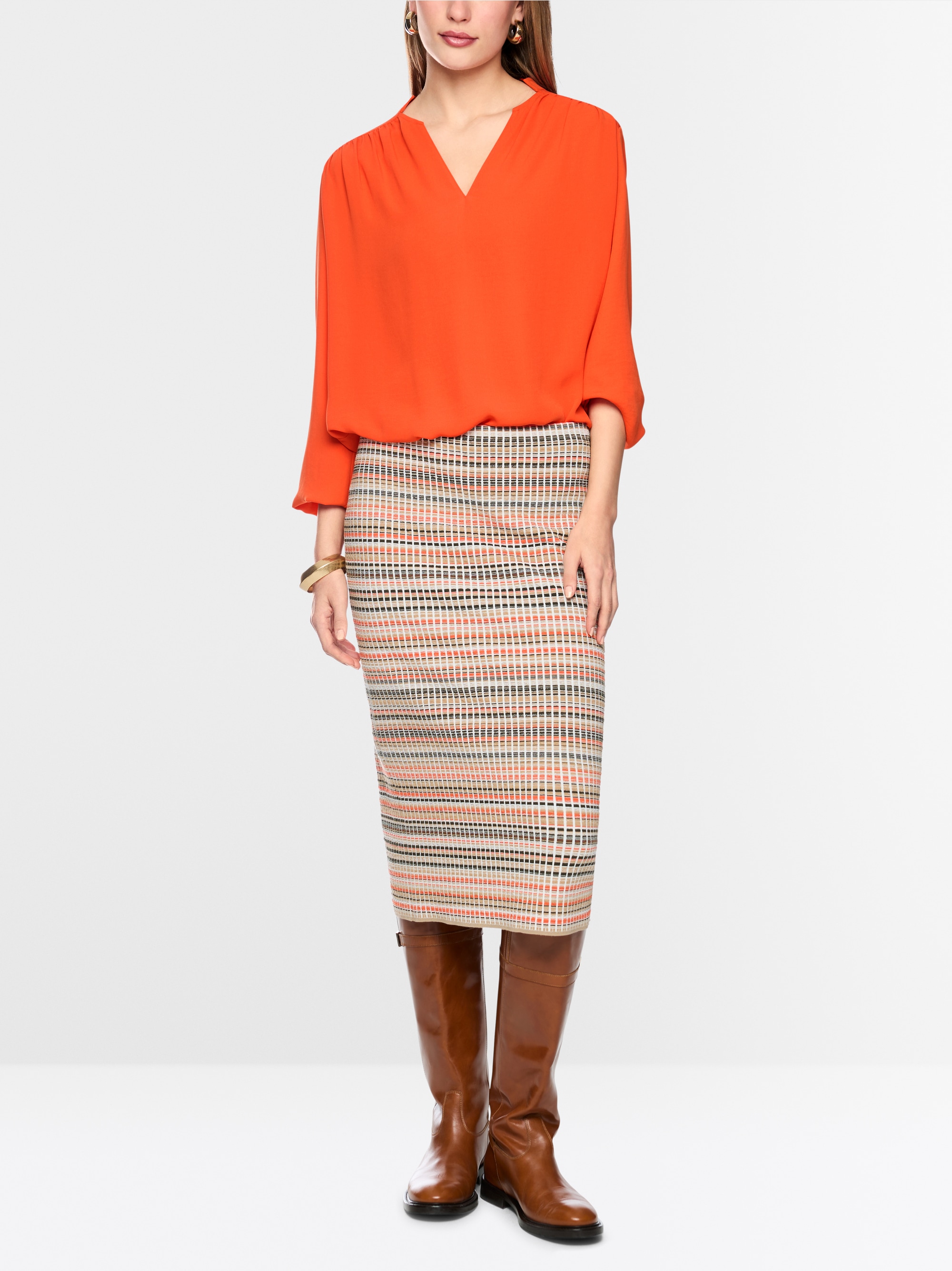 Flowing blouse with decorative button