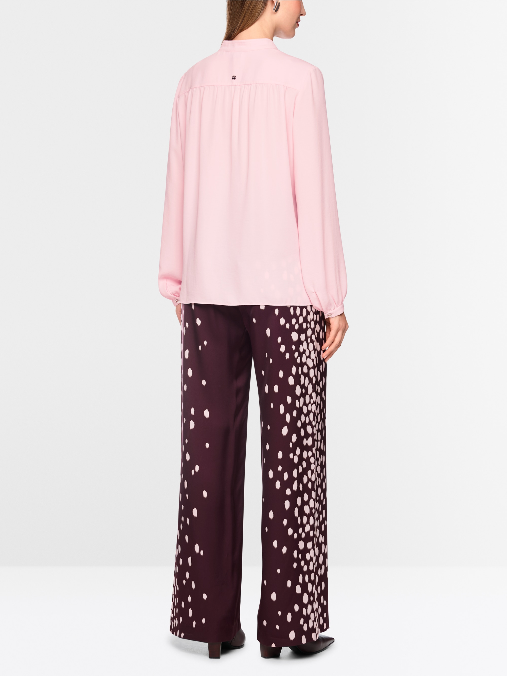 Flowing blouse with decorative button