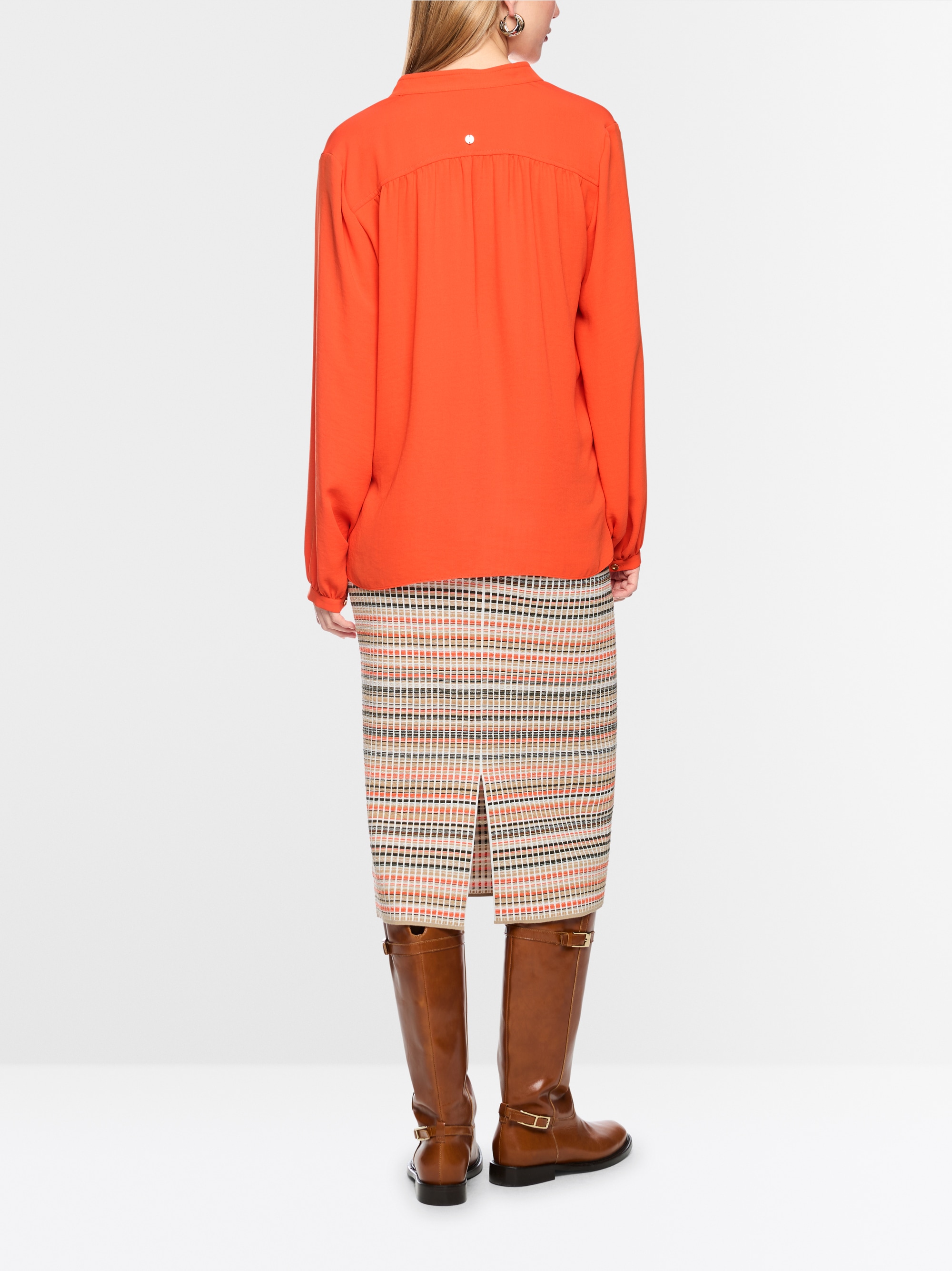 Flowing blouse with decorative button
