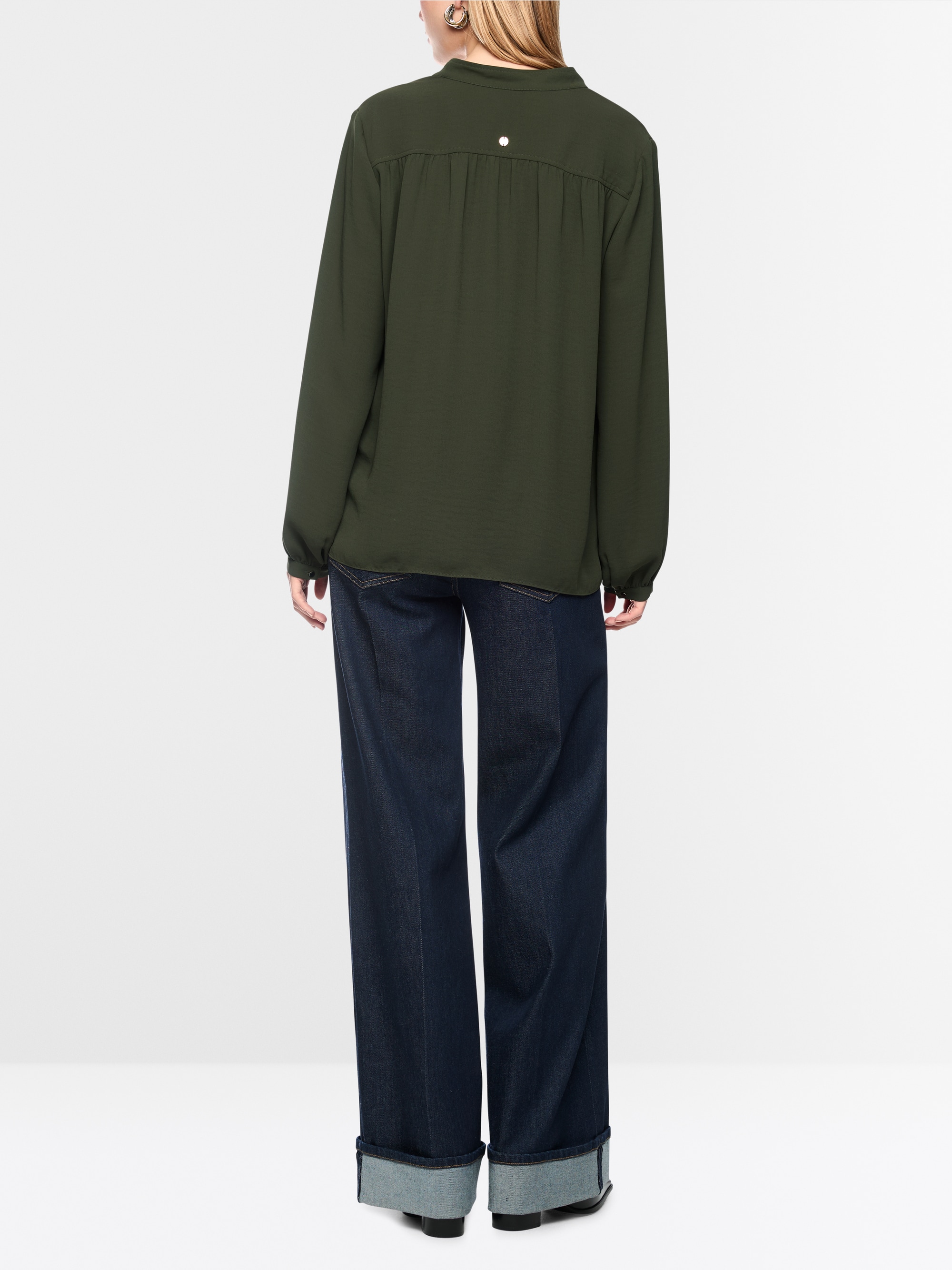 Flowing blouse with decorative button