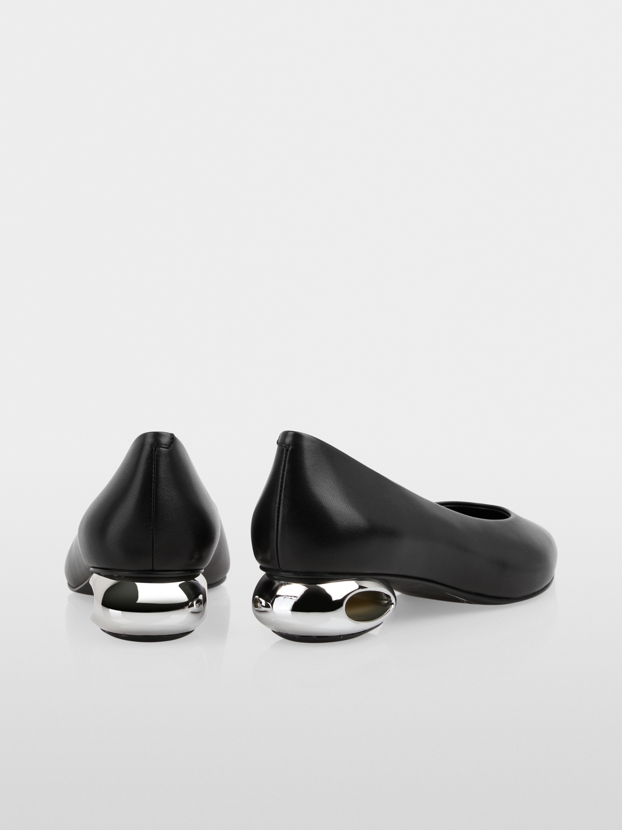 Pumps with metallic heel