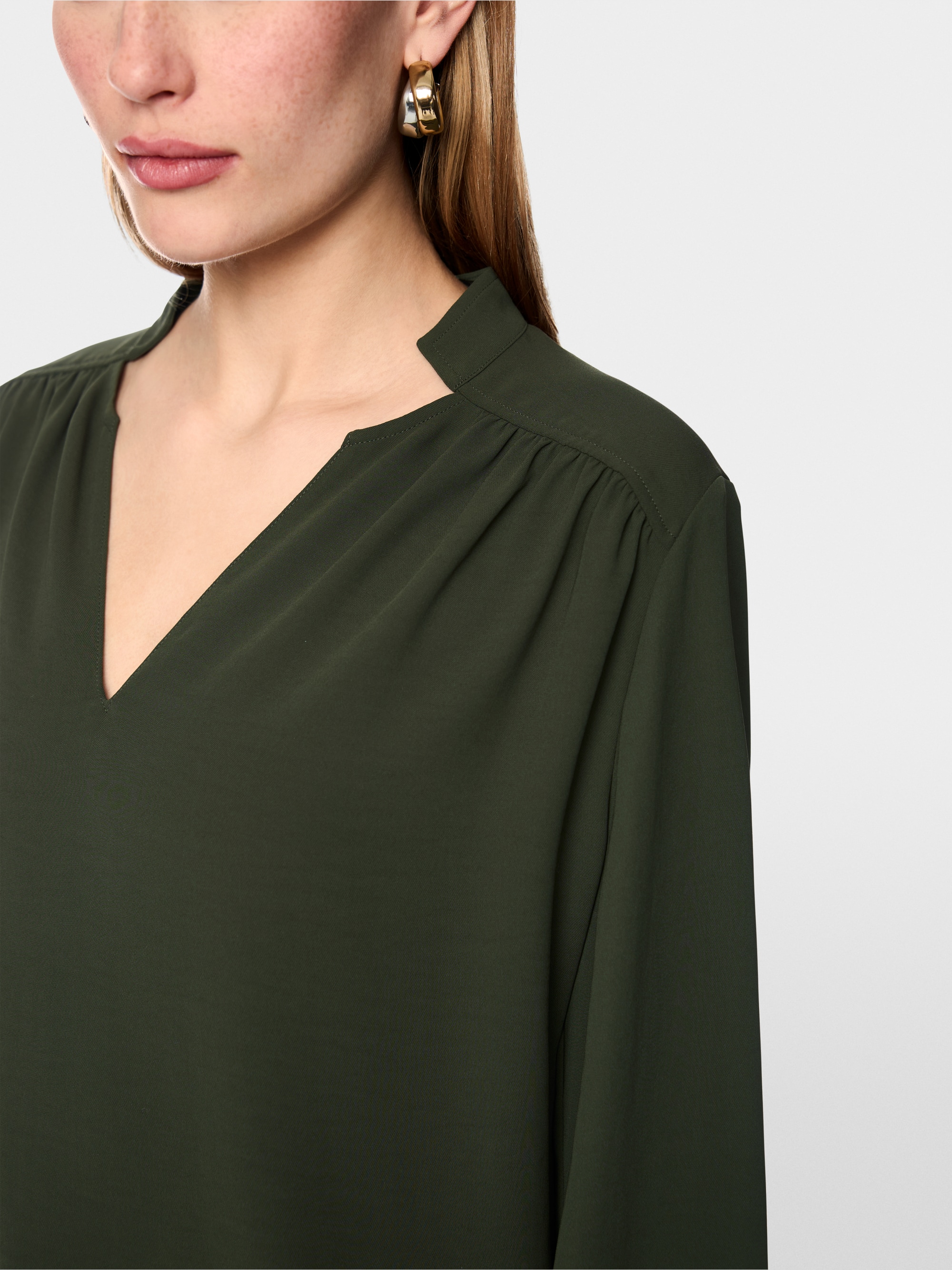 Flowing blouse with decorative button