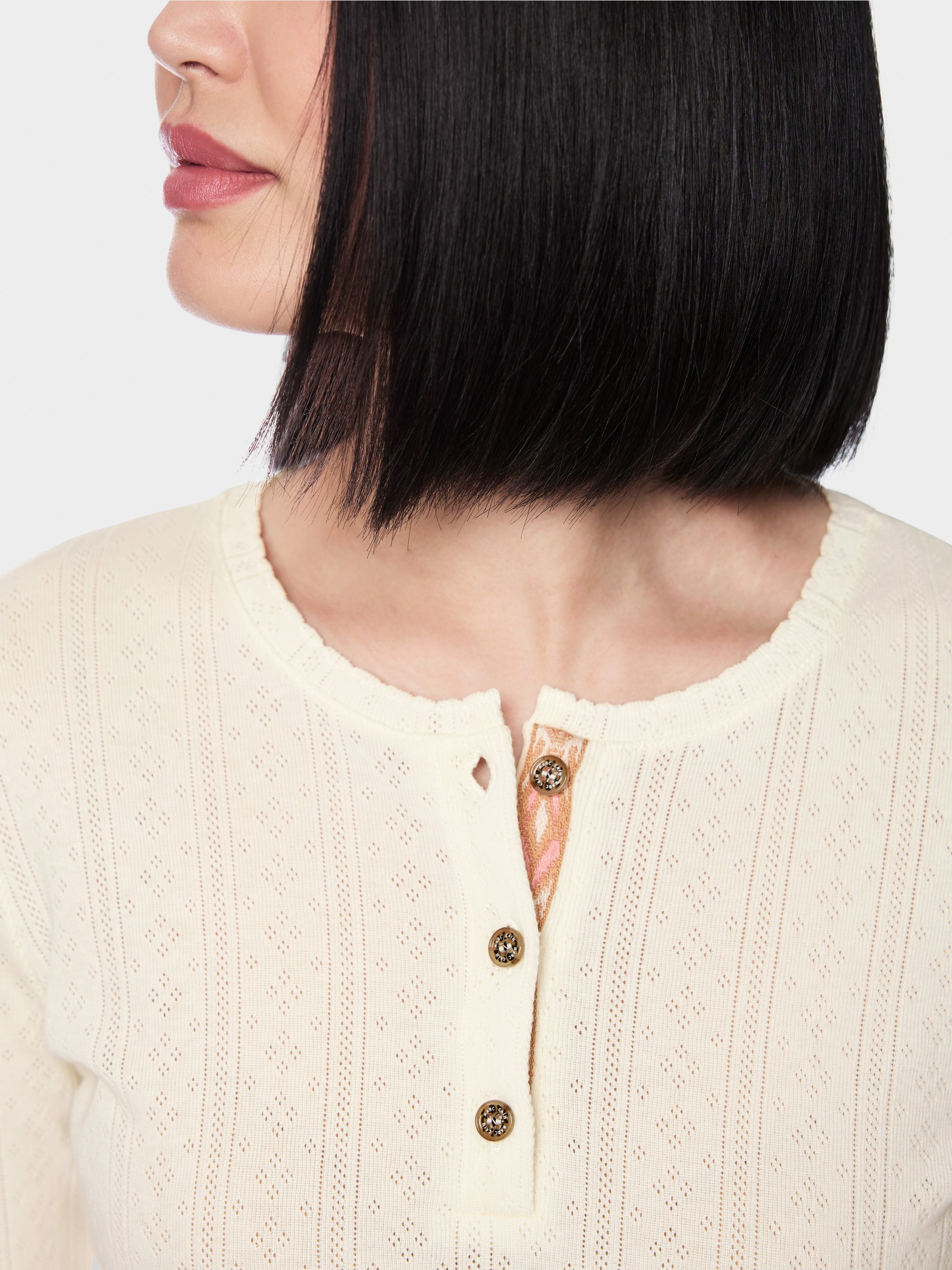Long-sleeved buttoned openwork top