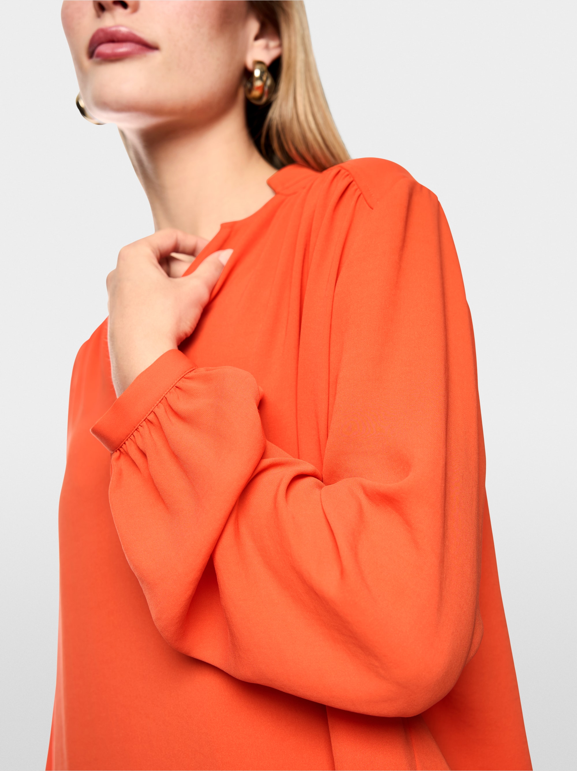 Flowing blouse with decorative button