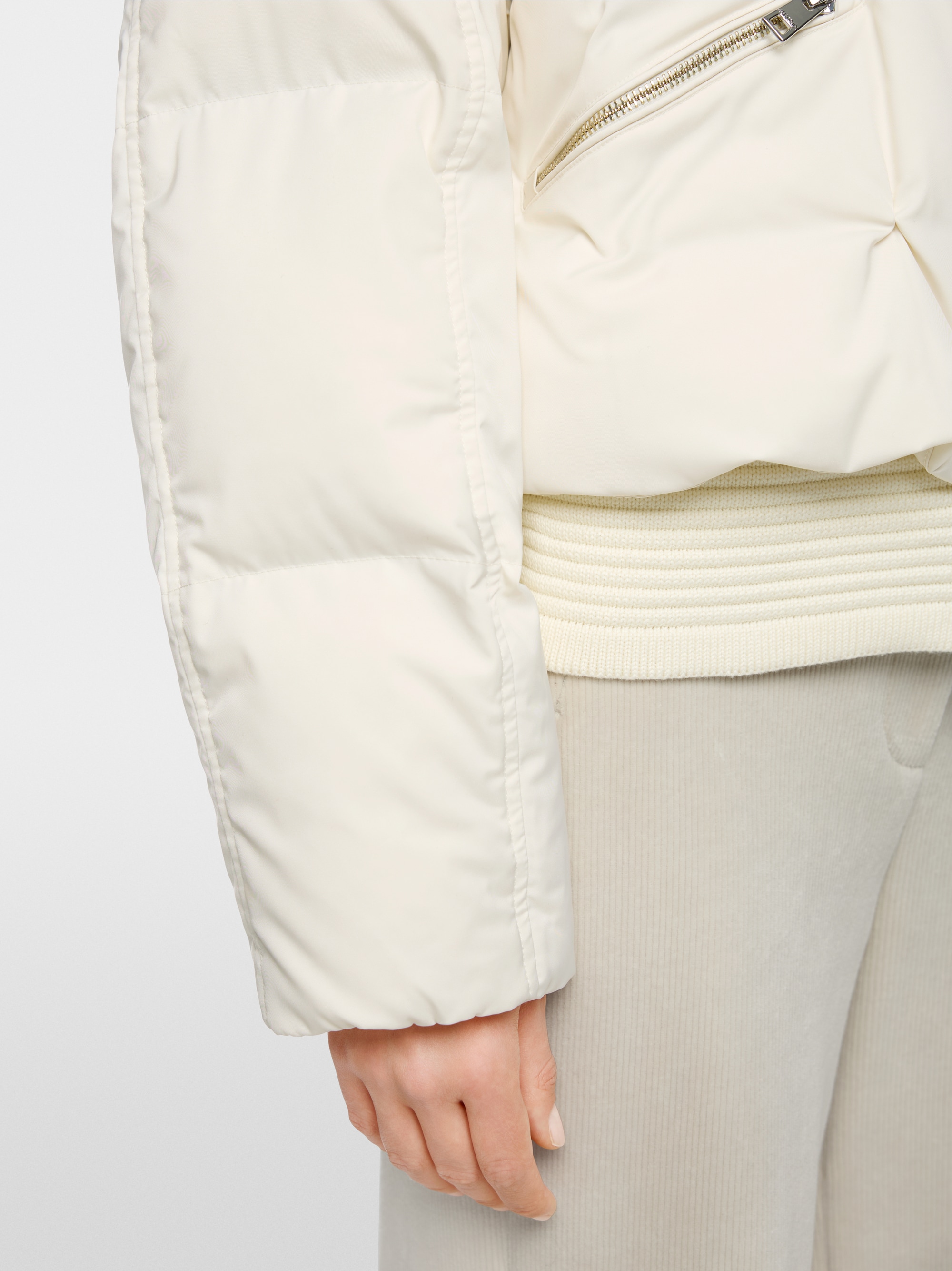 Quilted down jacket with knitted cuffs