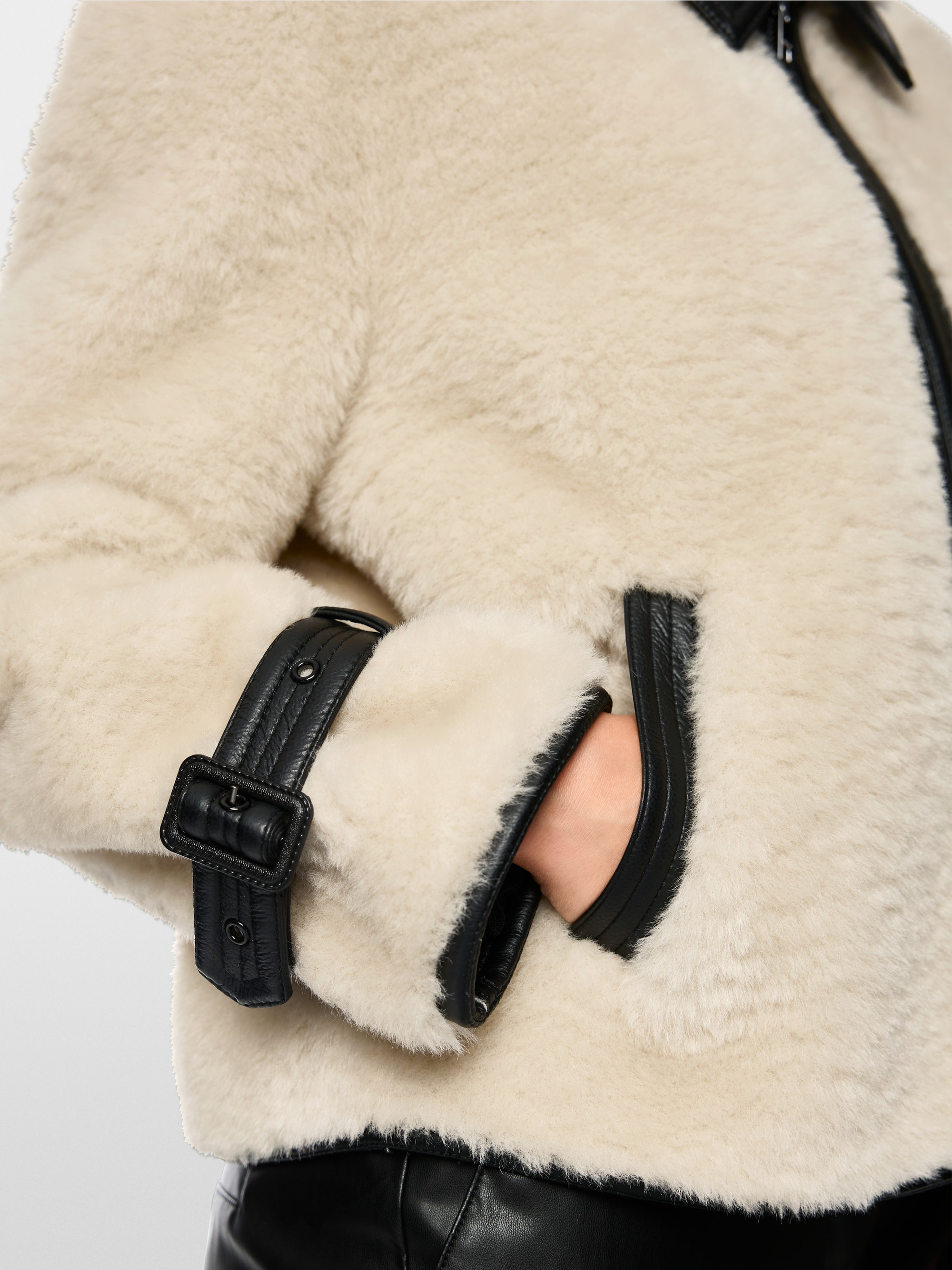 Faux fur jacket with strap detail