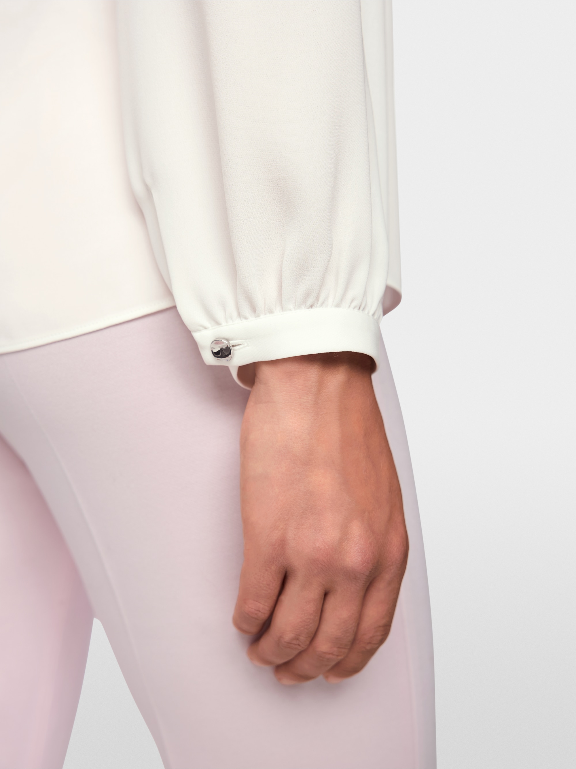 Flowing blouse with decorative button