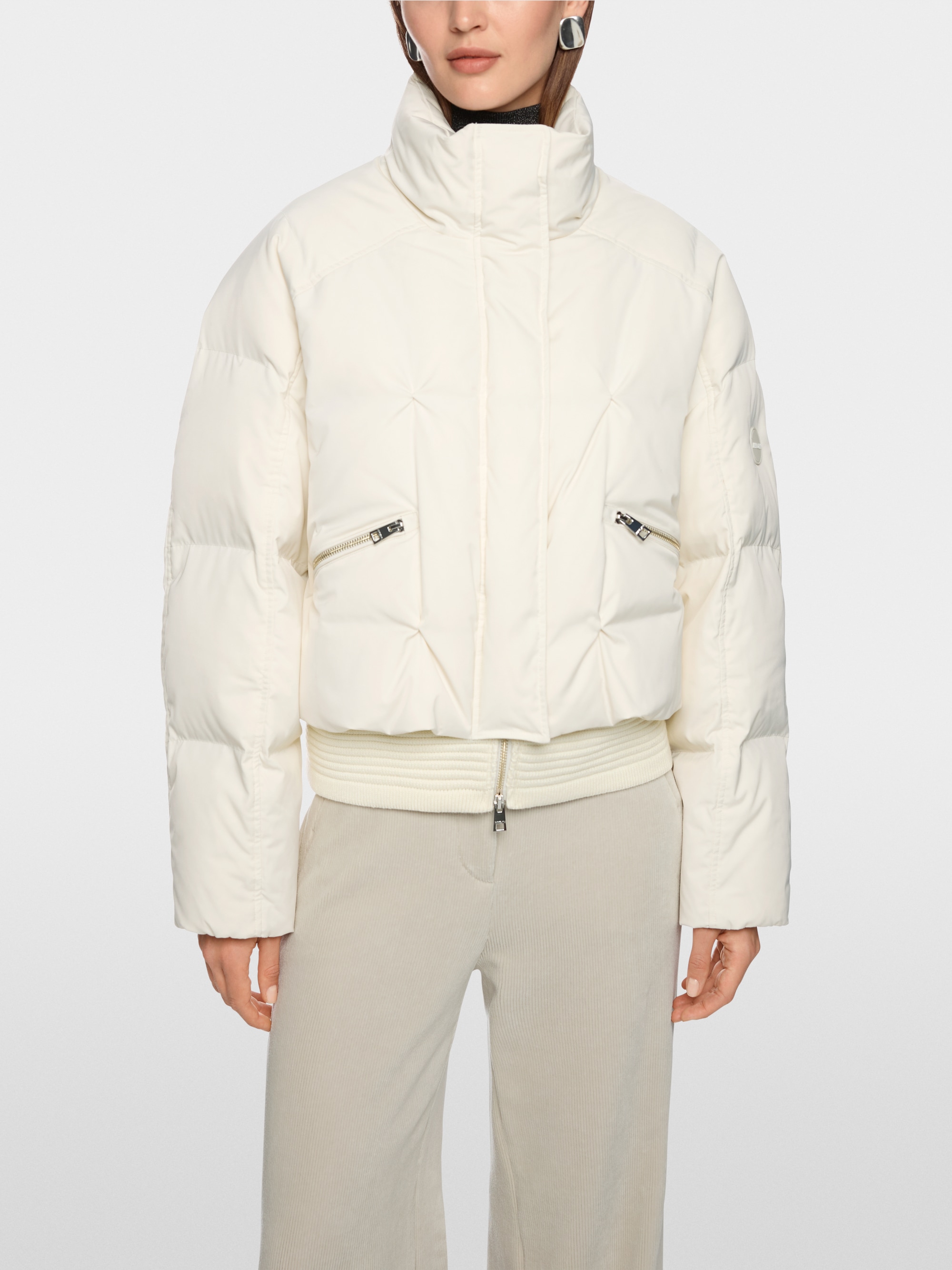 Quilted down jacket with knitted cuffs