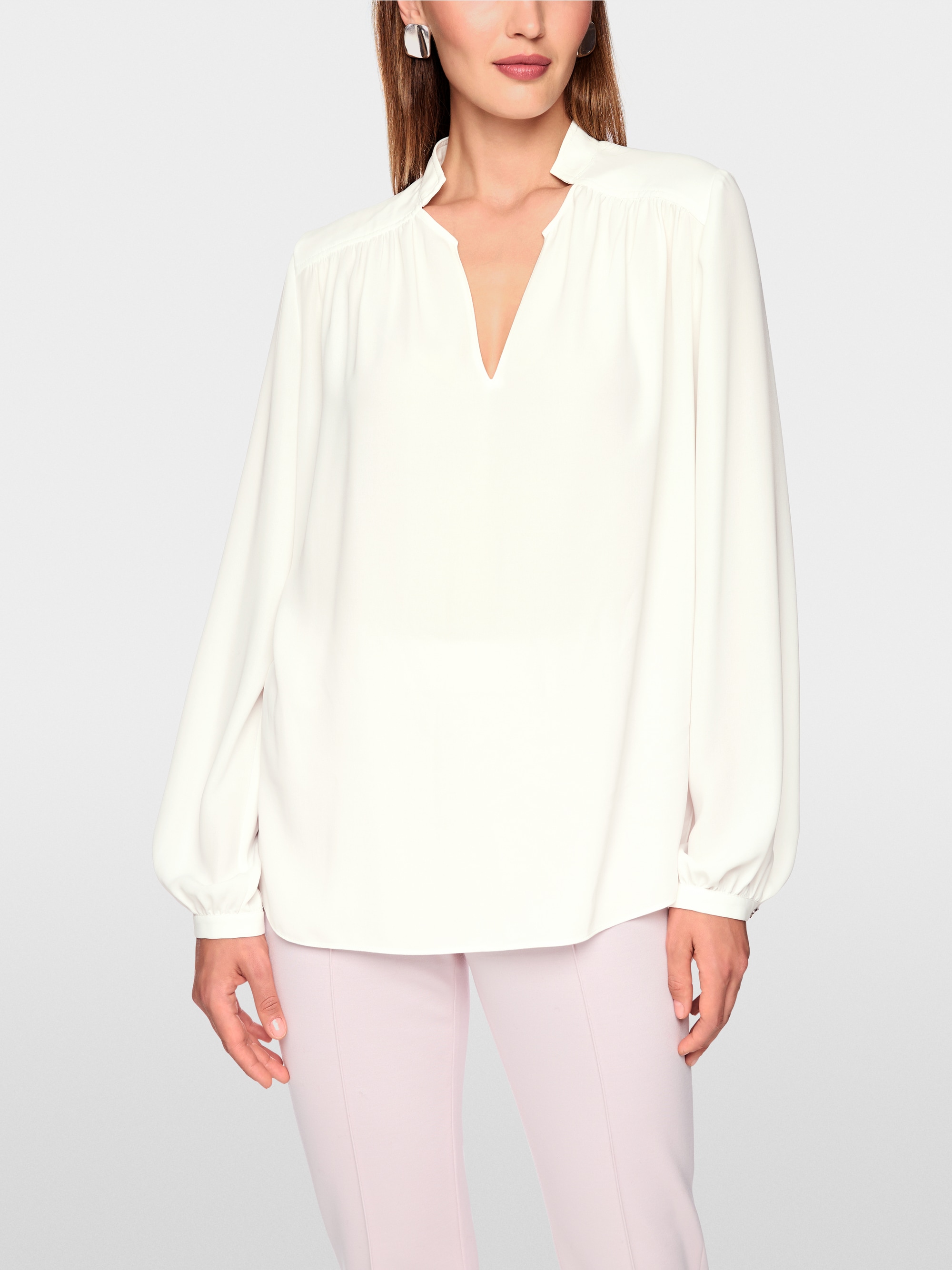 Flowing blouse with decorative button