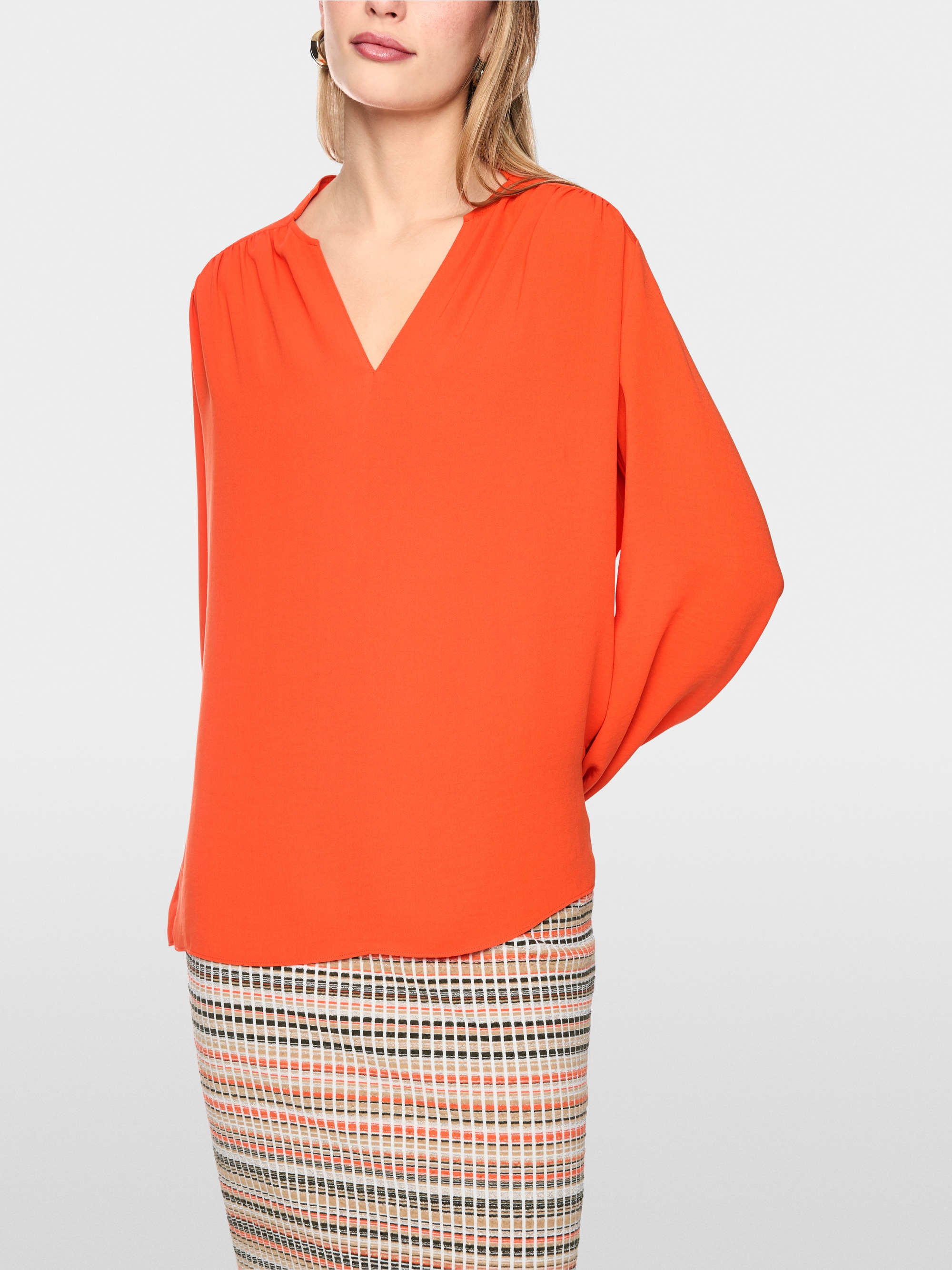 Flowing blouse with decorative button