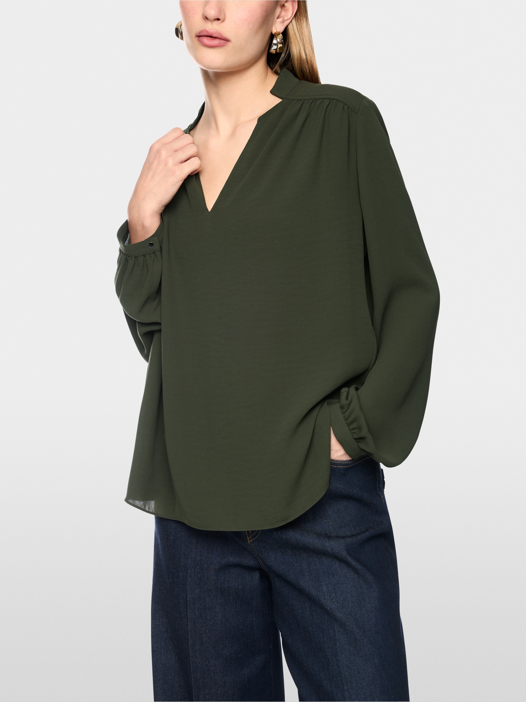 Flowing blouse with decorative button