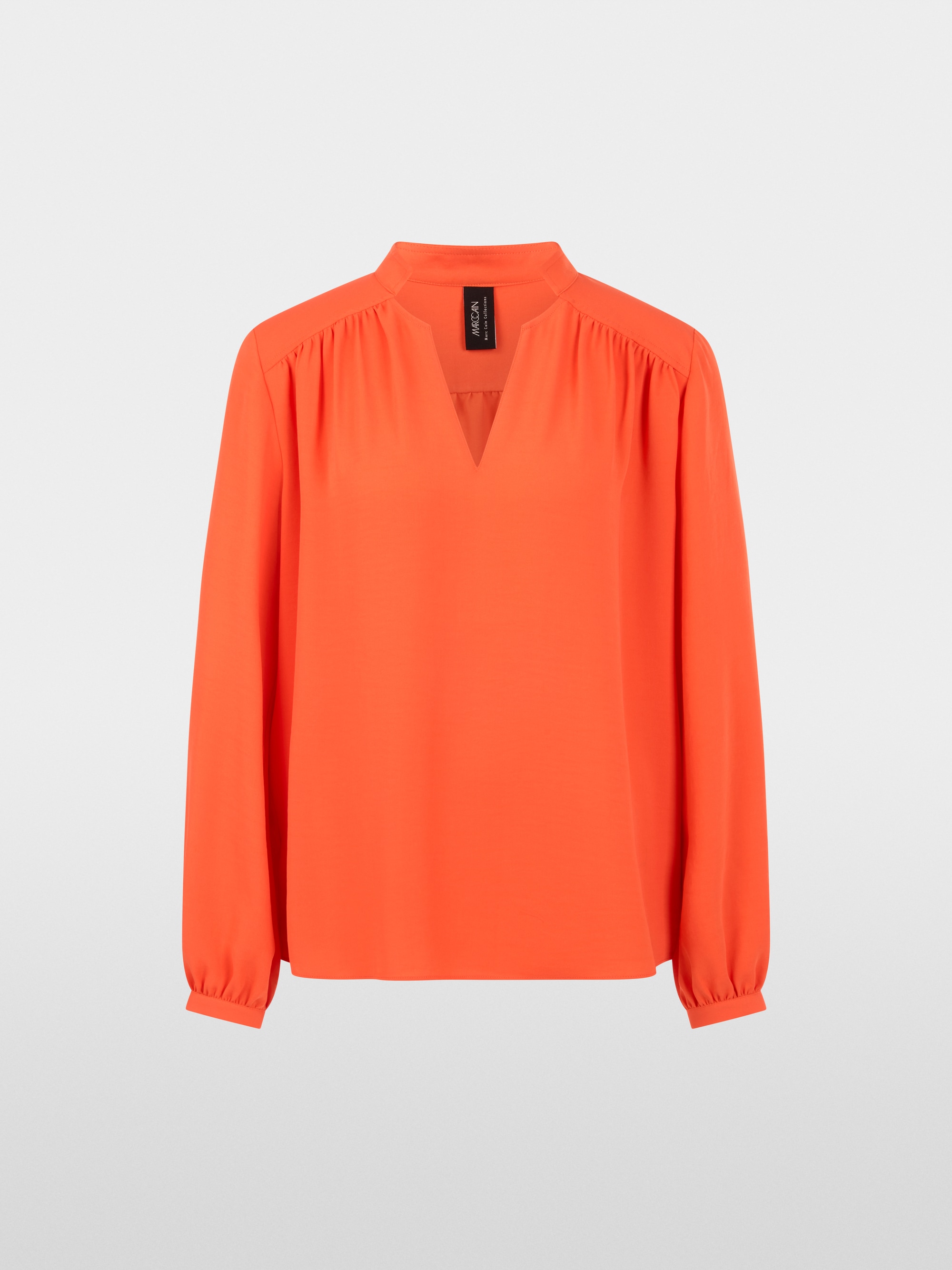Flowing blouse with decorative button