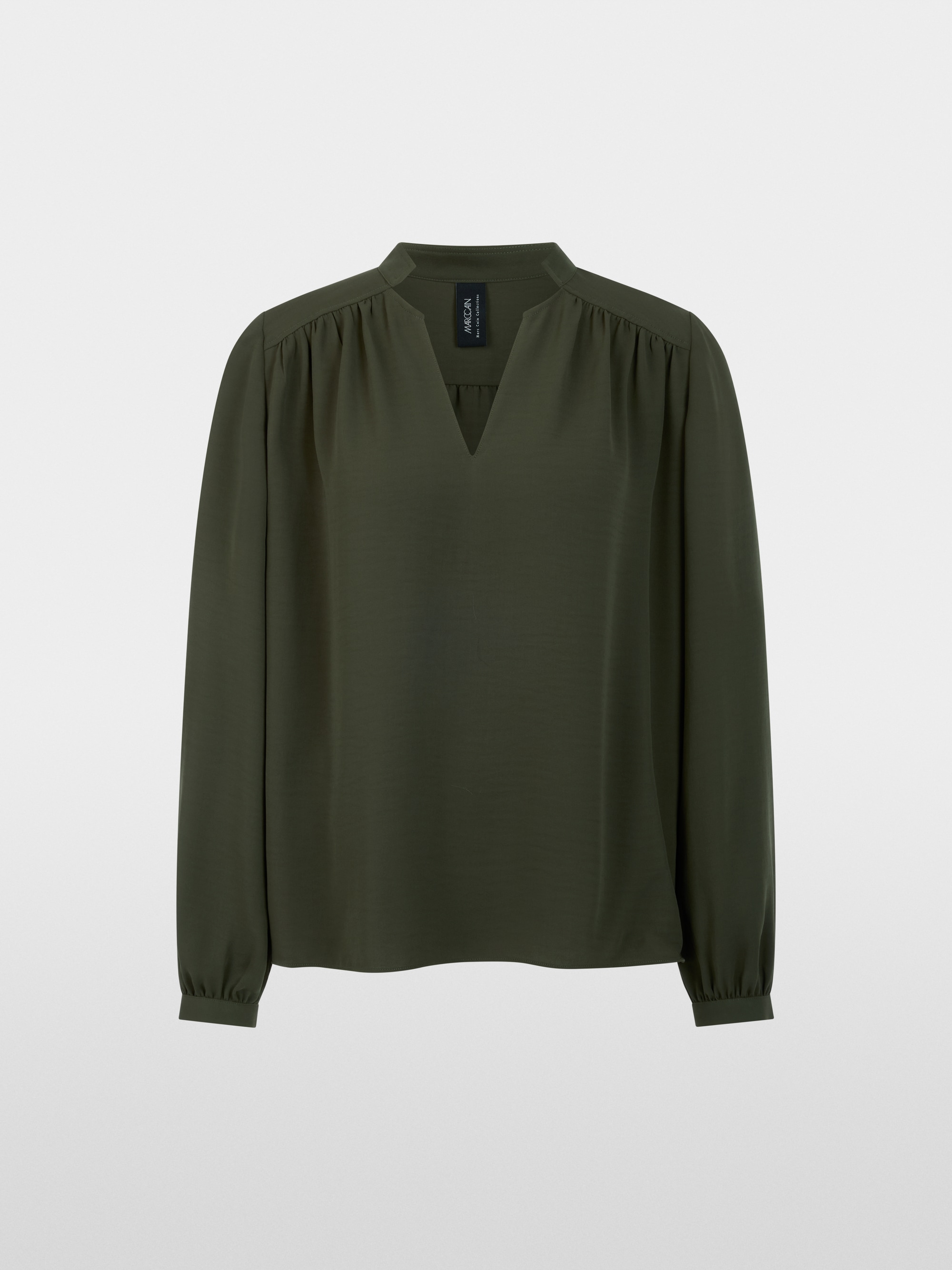 Flowing blouse with decorative button