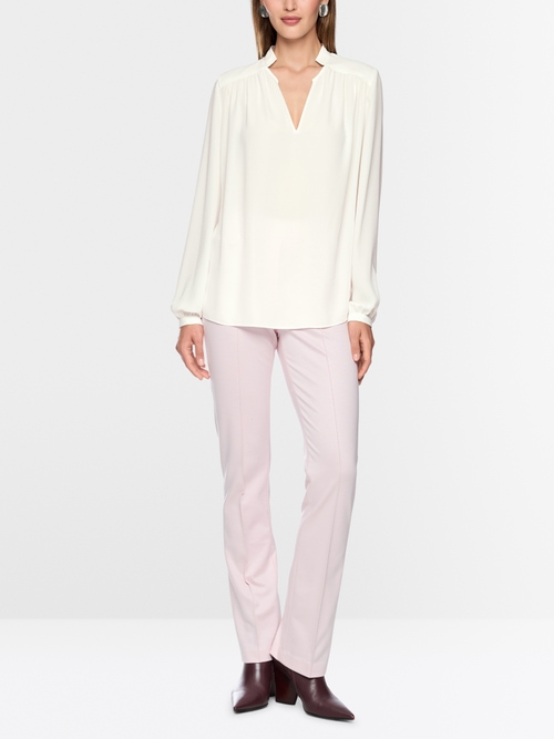 Flowing blouse with decorative button