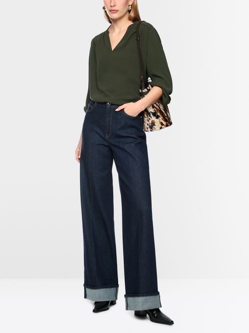 Flowing blouse with decorative button