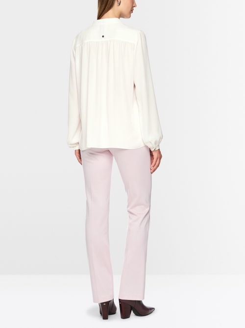 Flowing blouse with decorative button