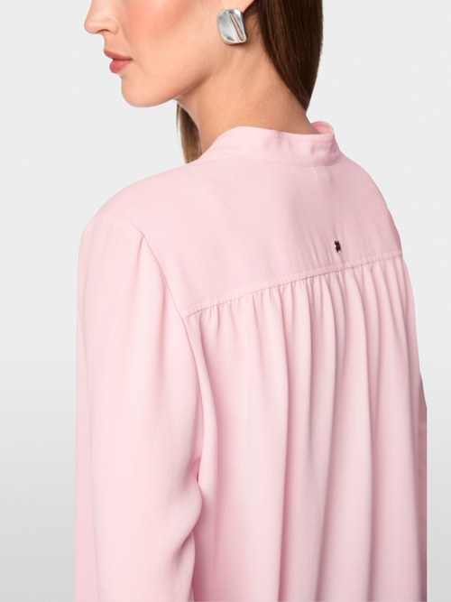Flowing blouse with decorative button