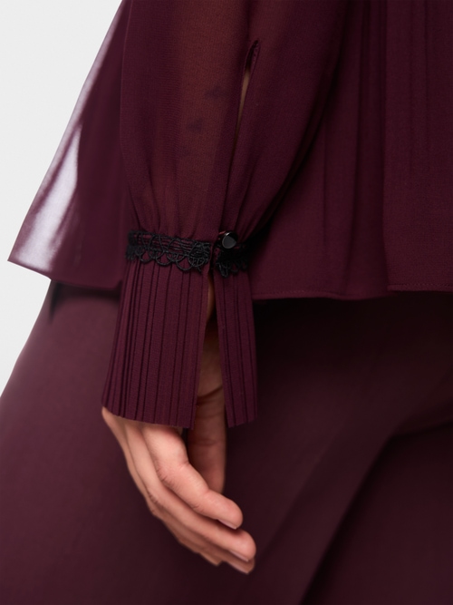 Pleated blouse with feminine details