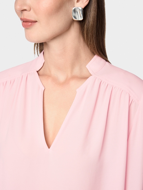Flowing blouse with decorative button