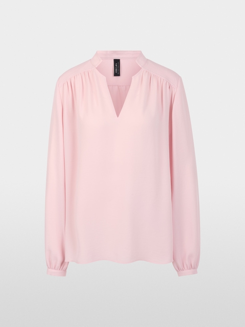 Flowing blouse with decorative button