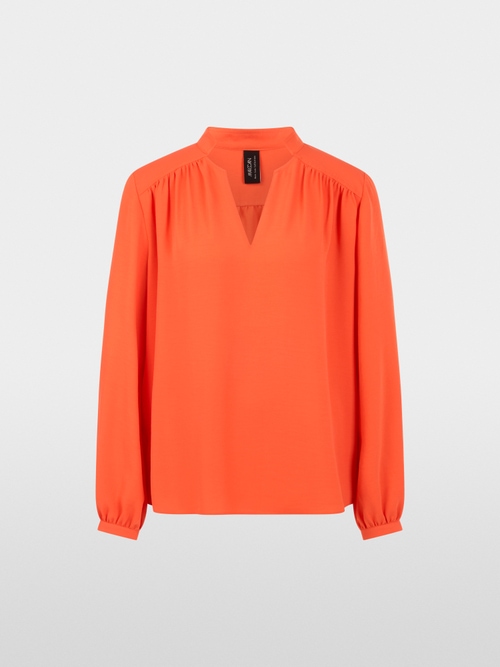Flowing blouse with decorative button
