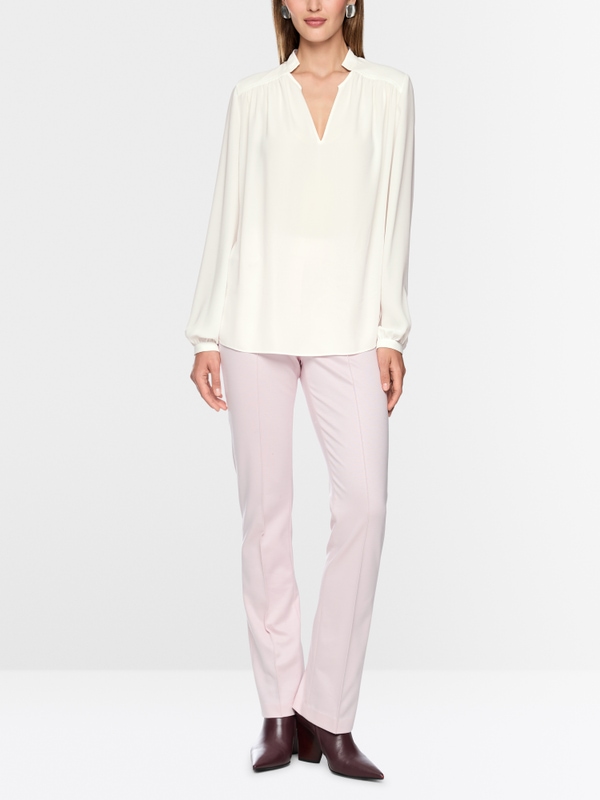 Flowing blouse with decorative button