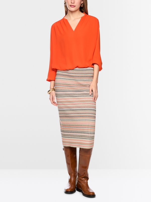 Flowing blouse with decorative button