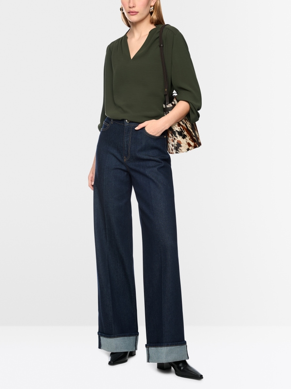 Flowing blouse with decorative button
