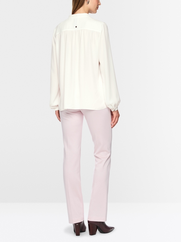 Flowing blouse with decorative button