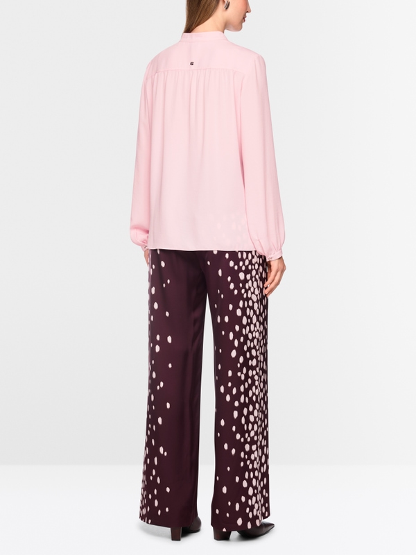 Flowing blouse with decorative button
