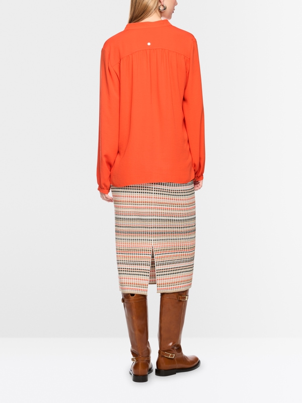 Flowing blouse with decorative button