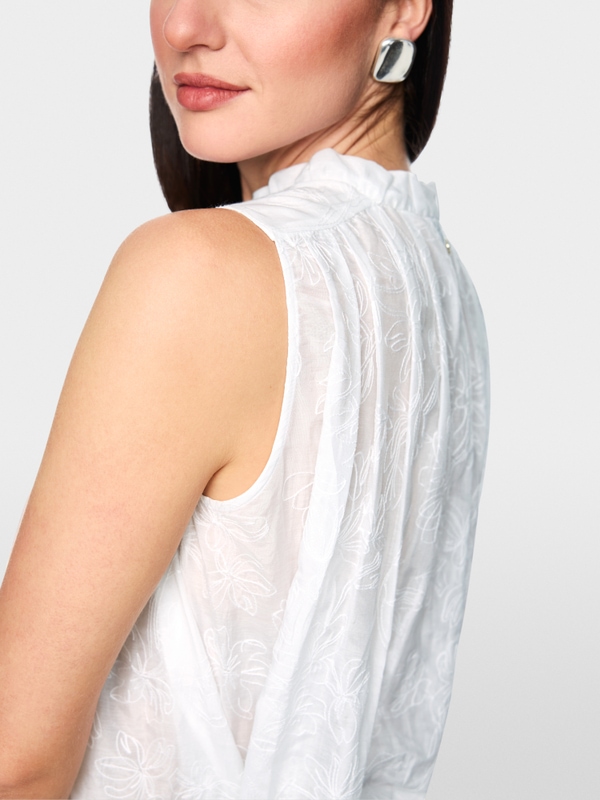 Top with ruffles & floral embroidery