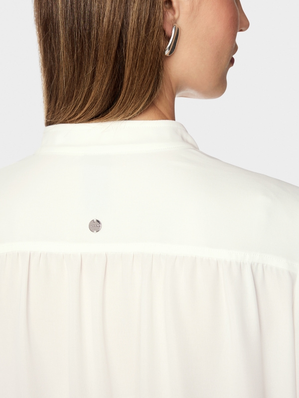 Flowing blouse with decorative button