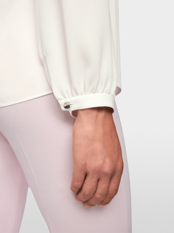 Flowing blouse with decorative button