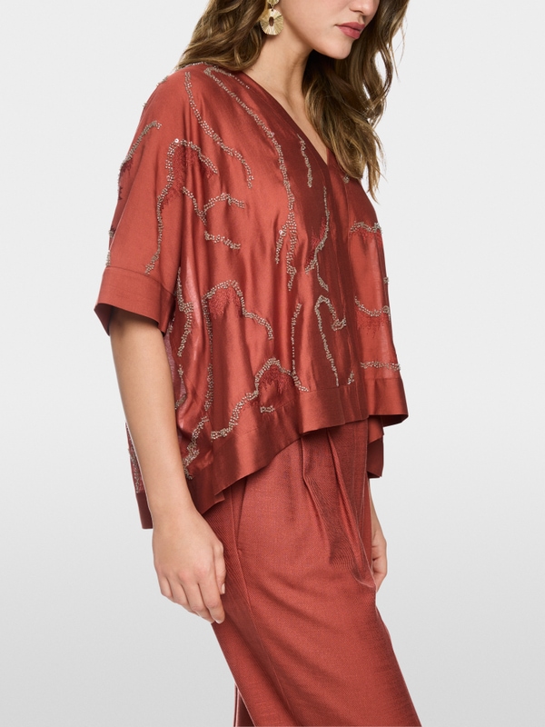 Flared blouse with embellishment