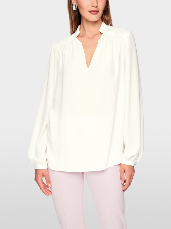 Flowing blouse with decorative button