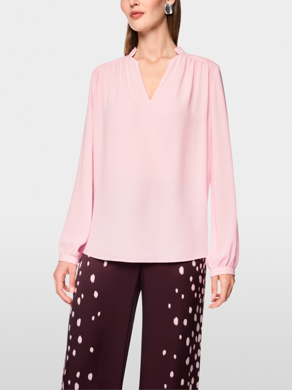 Flowing blouse with decorative button
