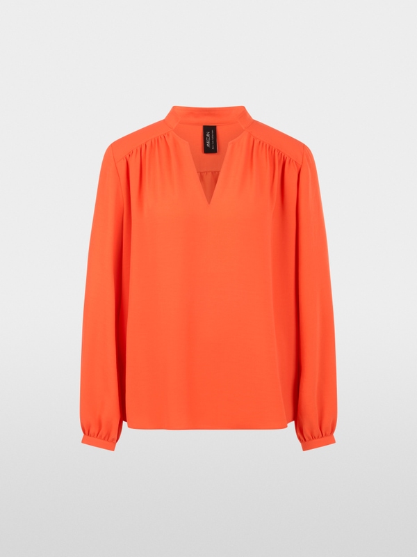 Flowing blouse with decorative button